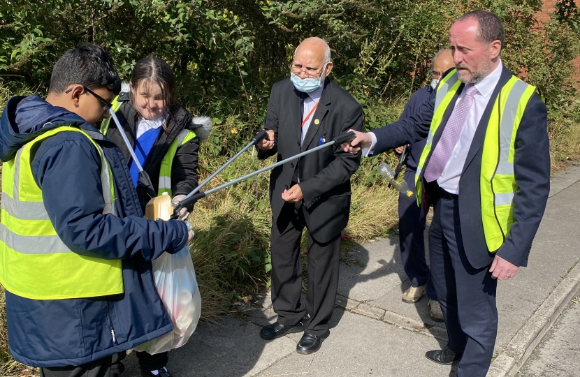 Eddie litter picking with the pupils from the school